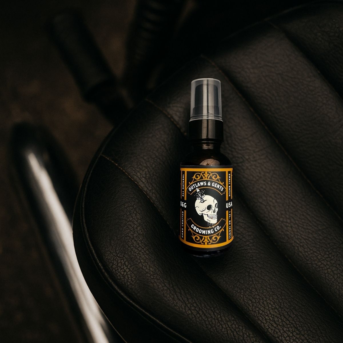 Outlaws and Gents Orange and Vanilla Grooming Oil on motorcycle seat