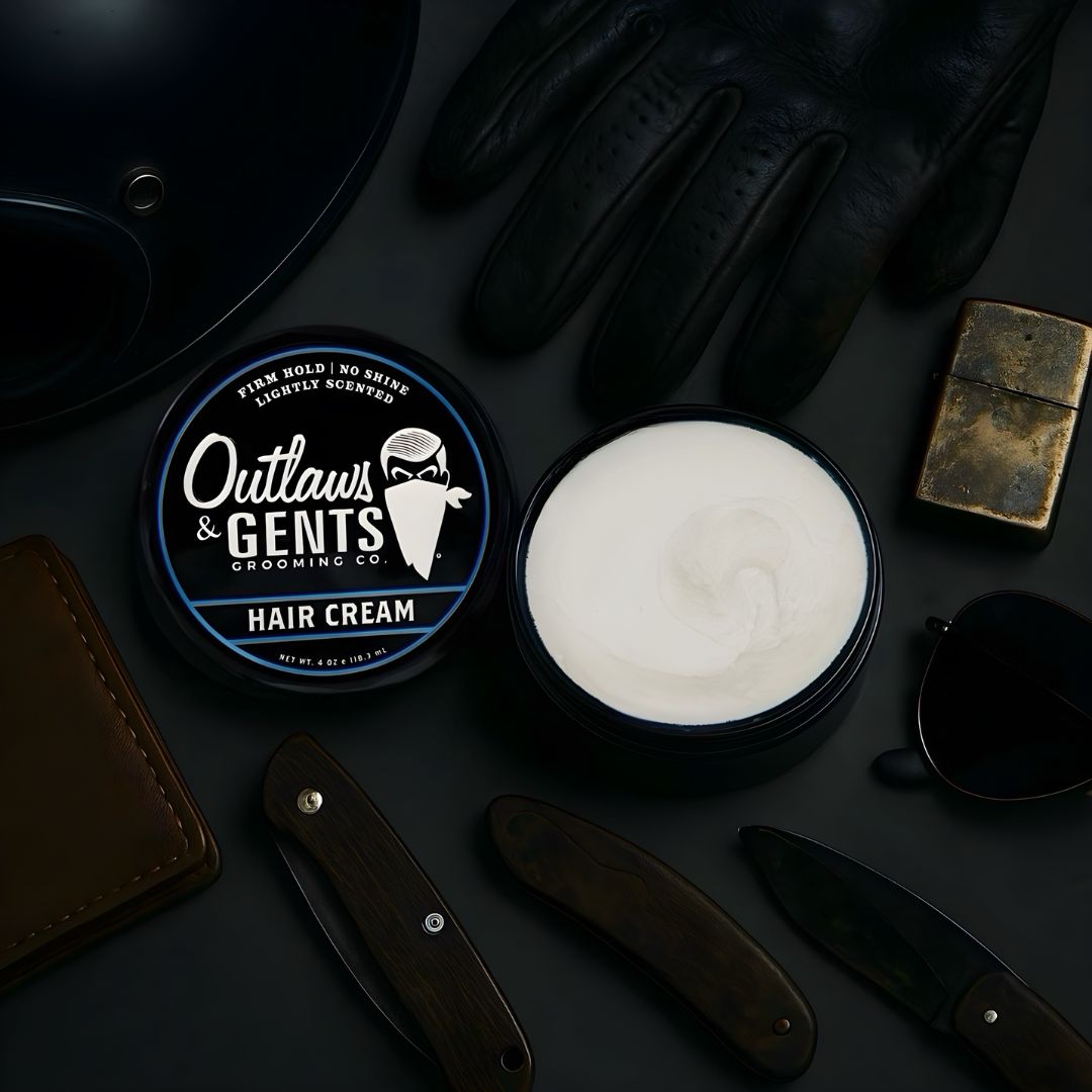 Outlaws and Gents hair cream with leather wallet, motorcycle helmet, riding glove, pocket knives and brass lighter